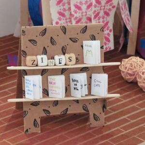 Close-up of a diorama depicting a miniature zine display