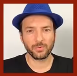 Headshot of Adian Gor, wearing a blue hat